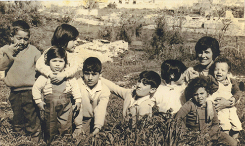 Amos family children with their uncle's wife Ester and cuisines in Musrara, 1960